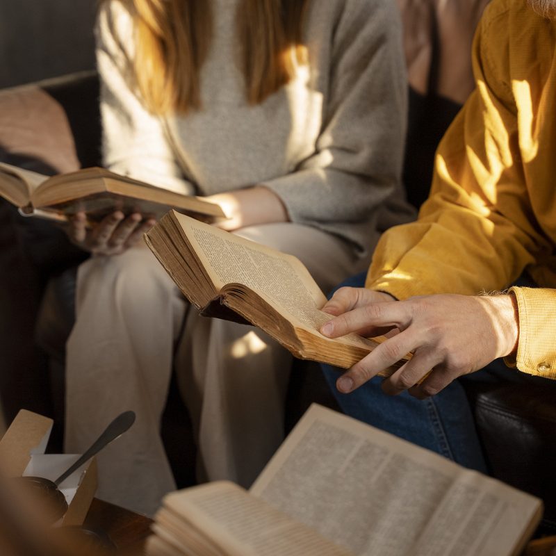 high-angle-people-reading-together